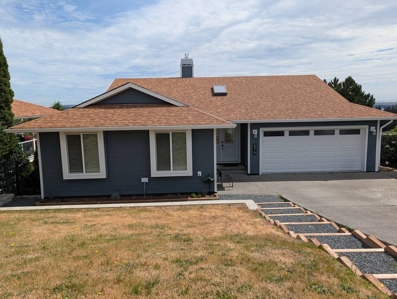Exterior siding replacement - after - blue Hardie plank